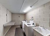Thumbnail 10 of 15 - A bathroom with a toilet, sink, and mirror.