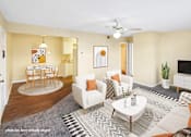 Thumbnail 1 of 30 - A living room with a white couch, a coffee table, and a ceiling fan.