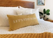 Thumbnail 1 of 16 - lets stay home pillow on a bed