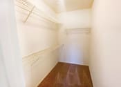 Thumbnail 3 of 16 - a walk in closet with shelves and a white wall