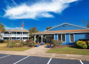 Thumbnail 13 of 16 - a blue building with a flag and a blue sky