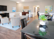 Thumbnail 8 of 16 - a dining room and living room with a table and chairs