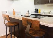 Thumbnail 5 of 16 - a kitchen with two stools in front of a counter