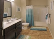 Thumbnail 6 of 12 - a bathroom with a toilet sink and bathtub