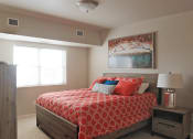 Thumbnail 4 of 12 - a bedroom with a bed and two windows