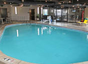 Thumbnail 7 of 12 - a large indoor swimming pool at apartment complex