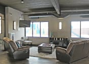 Thumbnail 9 of 12 - a living room with a tv and couches