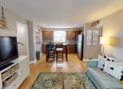 Thumbnail 1 of 10 - an open living room and kitchen with a table and chairs