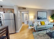 Thumbnail 3 of 10 - a living room with a refrigerator and a couch