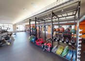 Thumbnail 19 of 34 - apartment gym with weights and other equipment