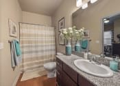 Thumbnail 8 of 34 - a bathroom with a toilet sink mirror and shower