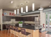 Thumbnail 14 of 34 - a large kitchen with an island and bar seating