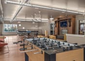 Thumbnail 15 of 34 - a game room with foosball and ping pong tables