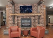 Thumbnail 17 of 34 - a rec room with a fireplace and chairs