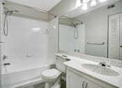 Thumbnail 4 of 29 - Full bathroom at the Earl Apartments with shower, tub, and large mirror
