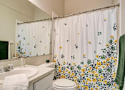 Thumbnail 20 of 29 - Bathroom with large mirror and tub