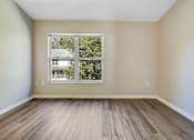 Thumbnail 11 of 29 - bedroom with large window and hardwood flooring