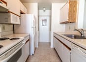 Thumbnail 1 of 25 - a kitchen with white appliances and wooden cabinets