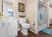 Thumbnail 12 of 31 - a bathroom with a toilet and a shower and a sink
