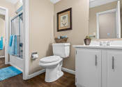 Thumbnail 11 of 31 - a bathroom with a toilet and a shower and a sink