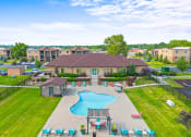 Thumbnail 26 of 31 - an aerial view of an outdoor swimming pool with umbrellas and tables and chairs