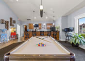 Thumbnail 18 of 31 - a game room with a pool table