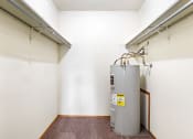 Thumbnail 11 of 23 - a room with a water heater and a radiator in the corner