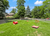Thumbnail 16 of 23 - fenced in dog park with agility equipment at Whispering Timbers Apartments