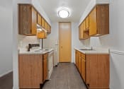 Thumbnail 2 of 23 - apartment kitchen with wood cabinets and white appliances