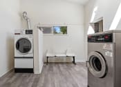 Thumbnail 15 of 23 - a washer and dryer in a laundry room