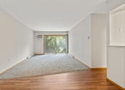 Thumbnail 3 of 23 - apartment living room with wood floors and a sliding glass door