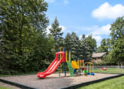 Thumbnail 17 of 23 - a playground with a slide at an apartment community