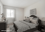 Thumbnail 7 of 23 - A bedroom with a large bed and a painting on the wall.