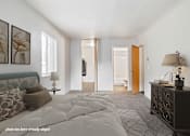 Thumbnail 6 of 23 - A bedroom with a large bed and a dresser.