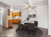 Thumbnail 3 of 23 - A modern kitchen with a dining table set for four.