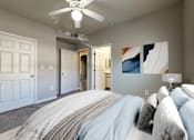 Thumbnail 3 of 28 - a bedroom with a bed and a ceiling fan