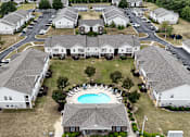 Thumbnail 28 of 29 - A large white building with a pool in the middle of it.