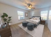 Thumbnail 4 of 25 - a bedroom with a bed and a ceiling fan