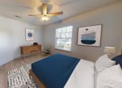 Thumbnail 5 of 25 - a bedroom with a bed and a ceiling fan