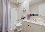 Thumbnail 13 of 27 - a bathroom with a shower toilet and sink