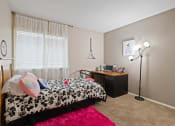 Thumbnail 5 of 27 - a bedroom with a bed and a dresser