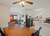 Thumbnail 9 of 27 - a kitchen and dining room with a wooden table