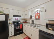 Thumbnail 3 of 27 - a kitchen with black appliances and white cabinets