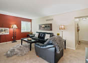 Thumbnail 6 of 27 - a living room with a couch and a chair