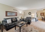 Thumbnail 1 of 27 - a living room with a couch and a table