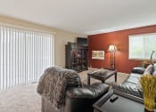 Thumbnail 7 of 27 - a living room with a leather couch and a table