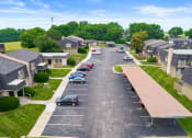 Thumbnail 26 of 27 - an aerial view of a neighborhood with cars parked in a parking lot