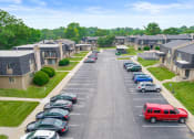 Thumbnail 25 of 27 - an aerial view of a parking lot with cars and houses