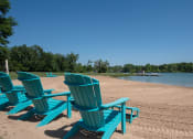 Thumbnail 20 of 26 - a group of blue beach chairs sitting on the beach