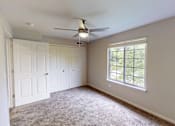 Thumbnail 9 of 35 - A room with a ceiling fan and a window.